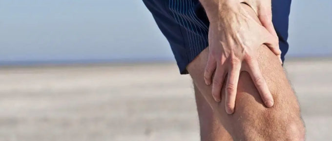 man holding his painful knee